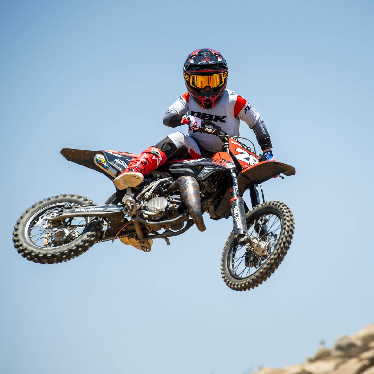 Youth motocross jersey on rider, light gray with red accents and black lower section