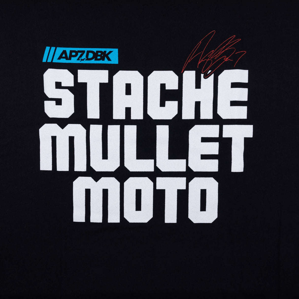 Youth premium tee, black, close-up of “STACHE MULLET MOTO” stacked bold lettering