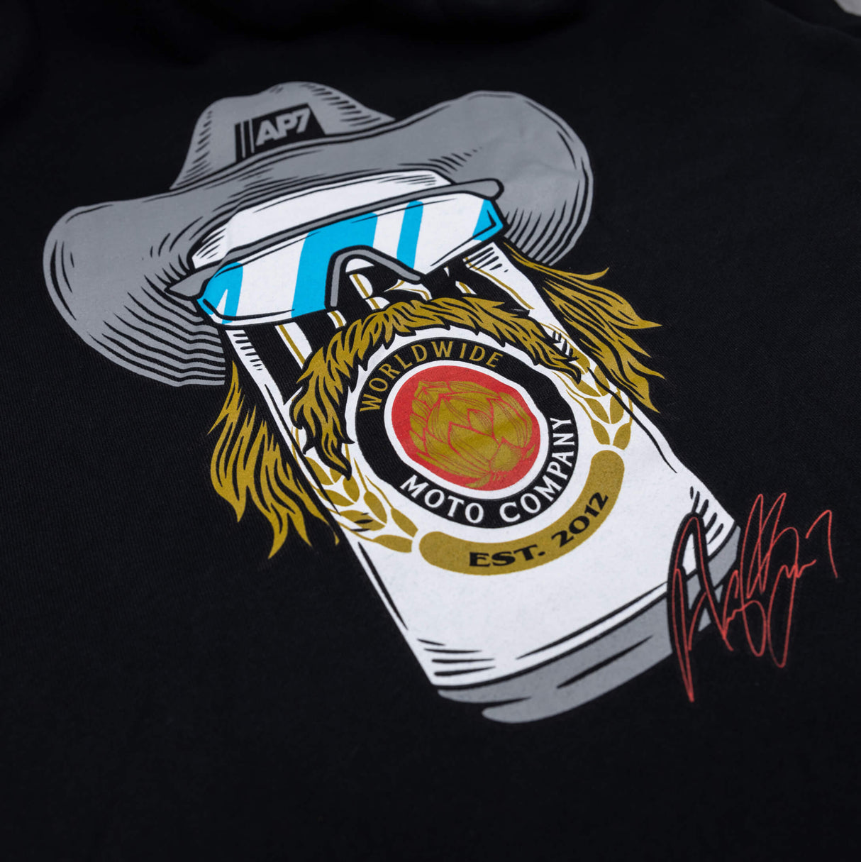 Black hoodie close-up of moto face emblem with goggles and bearded detail