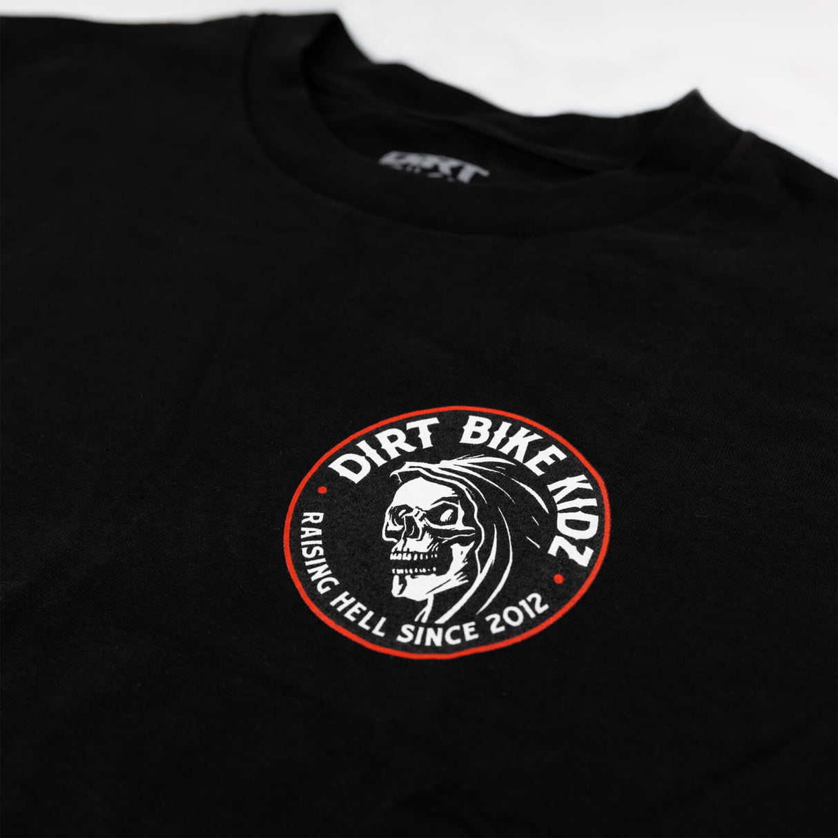 Reaper tee black close-up, small Dirt Bike Kingdom front logo graphic