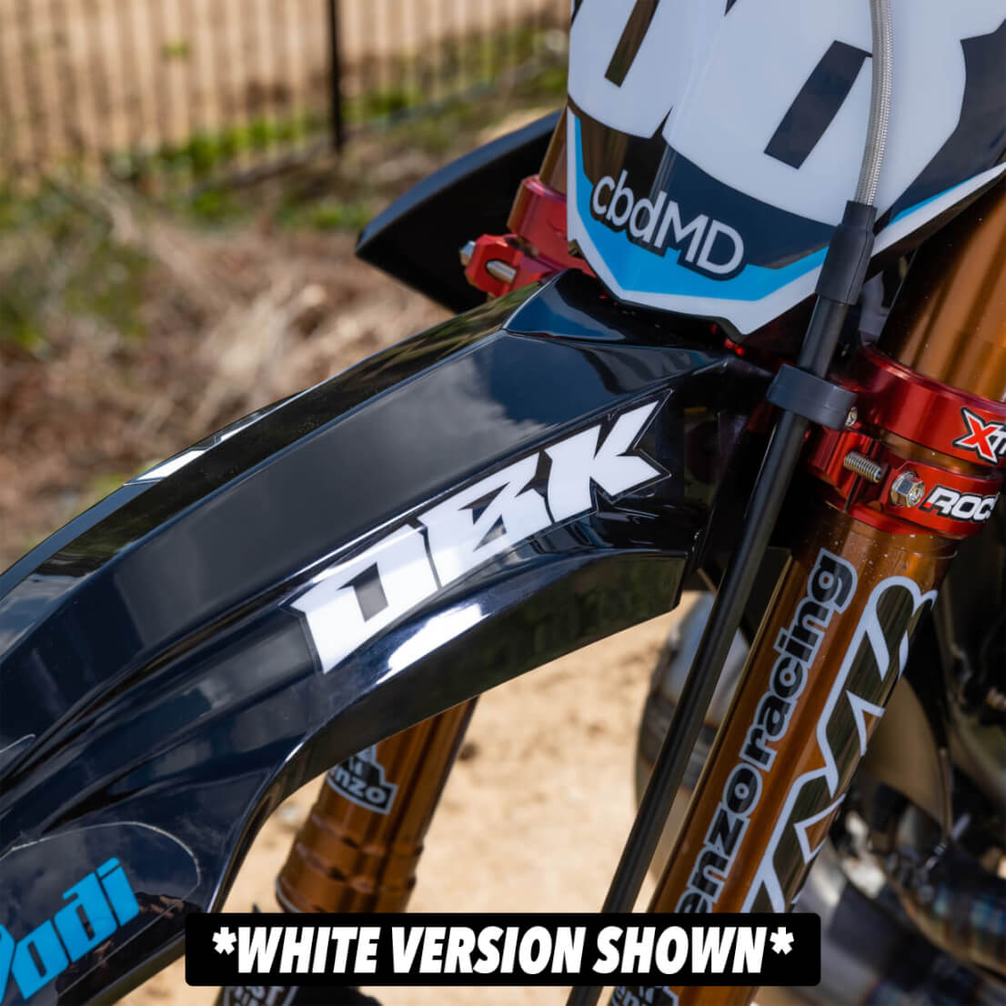Black-and-white racer fender decal on a motorcycle side panel, angled close-up.