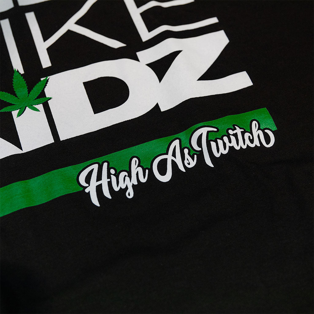 Black kids graphic T-shirt close-up of green stripe with "High As Truth" script
