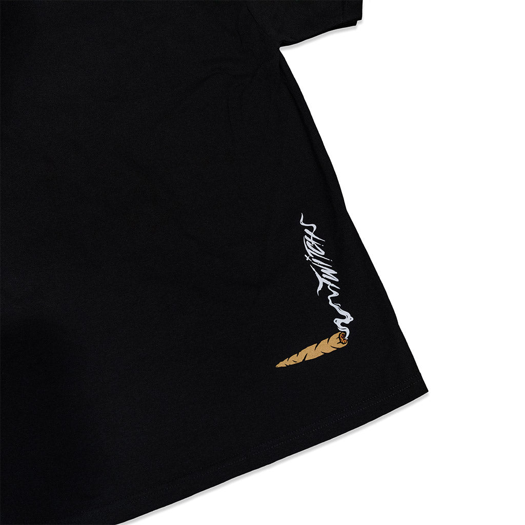 Black T-shirt side seam view with white flame graphic and small brown icon