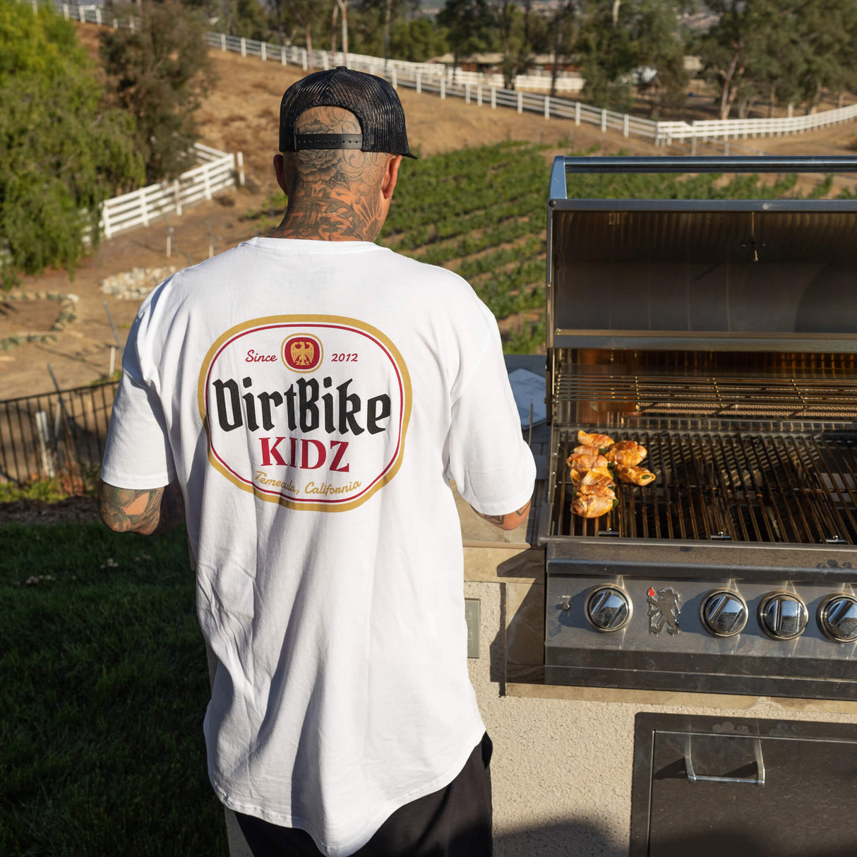 Premium tall tee back view, white, with DirtBike KIDZ oval logo graphic
