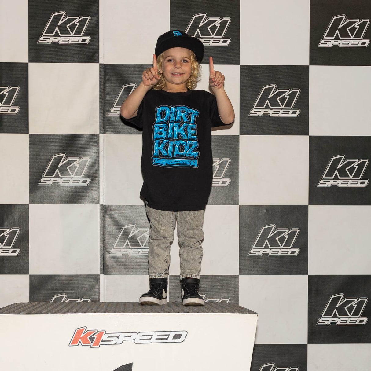 Youth tee worn at event: black shirt with blue “DIRT BIKE KIDZ” front graphic