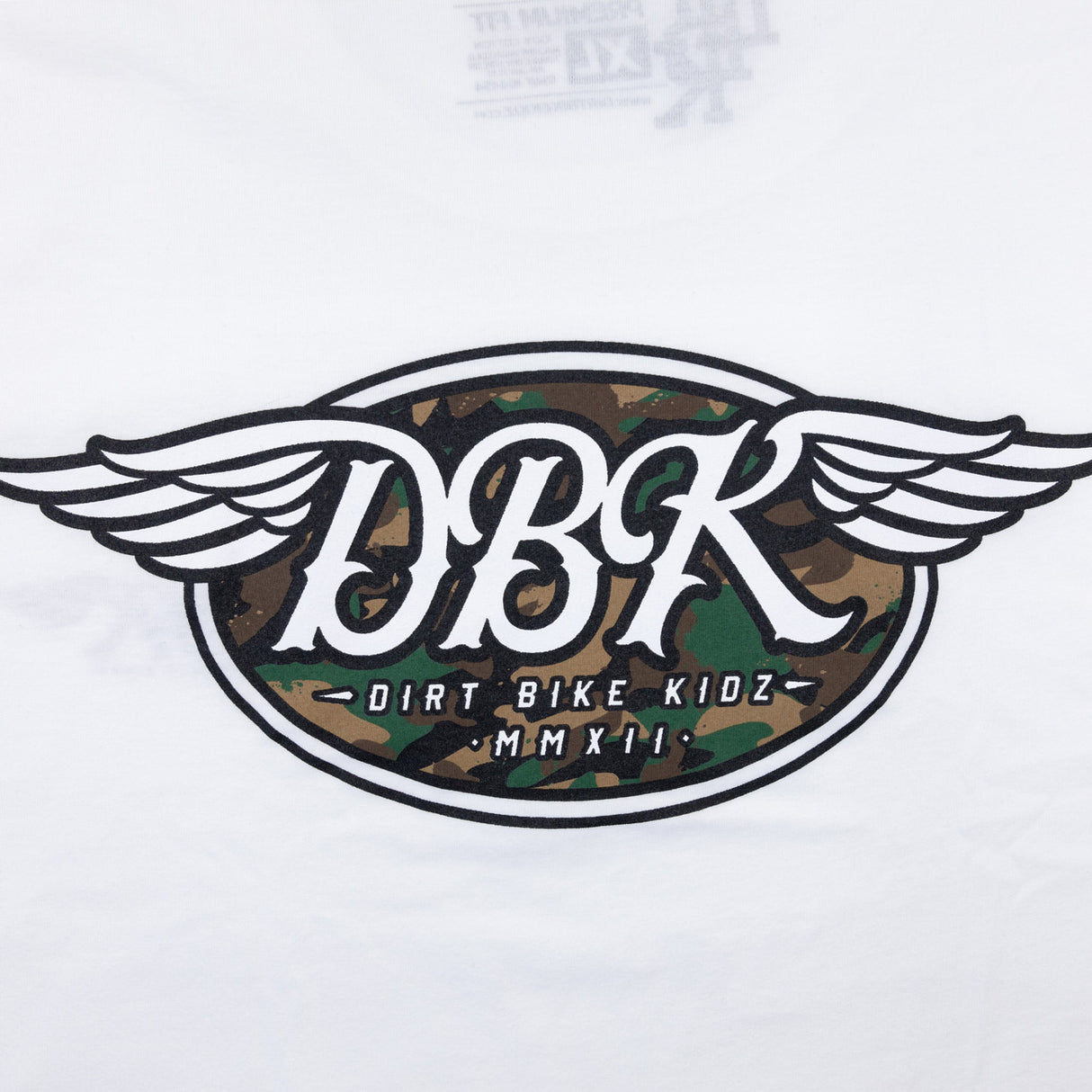 White tall tee close-up with large winged DBK emblem and camo-style graphic center