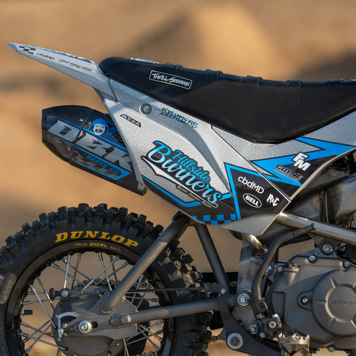 Motocross bike side panel with blue, black, and white decals and number-style graphics