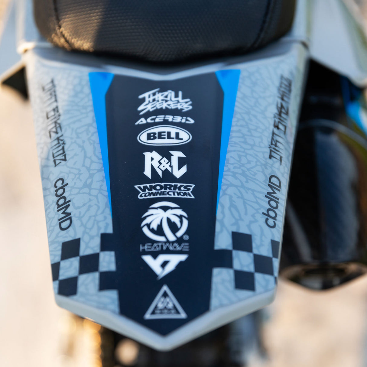 Motocross side shroud in dark blue with light blue panels and checkered accents