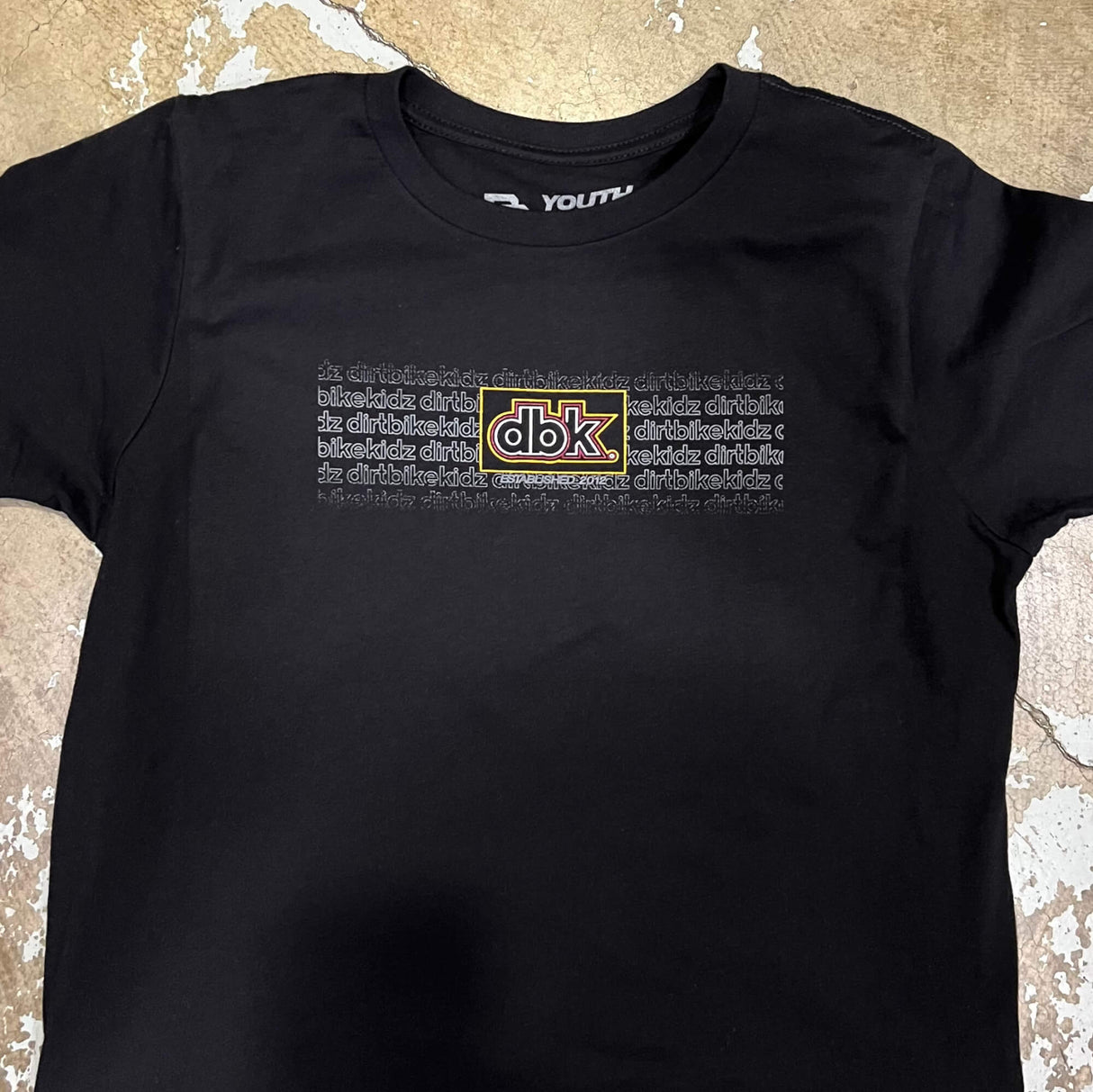 Black youth crewneck tee, chest logo graphic with dbk text