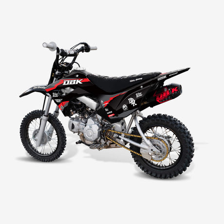 Pit bike with custom DBK graphic kit installed, black and red motocross decal kit on pit bike