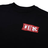 Black Shifting Gears tee close-up of red DBK logo patch
