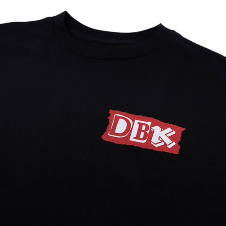 Black Shifting Gears tee close-up of red DBK logo patch