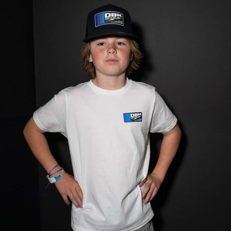Youth premium tee worn by a child, white with a small DBK logo graphic on the chest