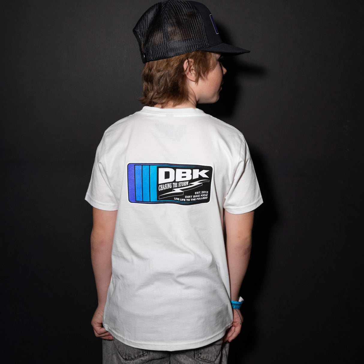 Youth premium tee back view, white with centered DBK logo graphic