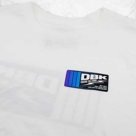 Youth premium tee chest logo close-up, white with DBK graphic