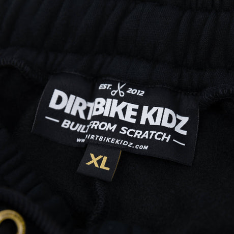 Black premium sweatpants waistband with size label and printed logo tag