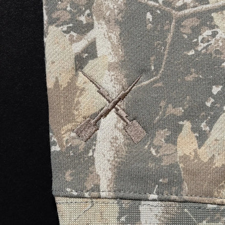 Youth camouflage hoodie hem and drawstring tips detail.