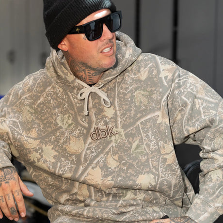 Backwoods camouflage hoodie with hood drawstrings and “dbk” logo