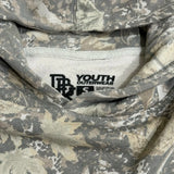 Youth camouflage hoodie neck label showing “YOUTH OUTERWEAR” branding.