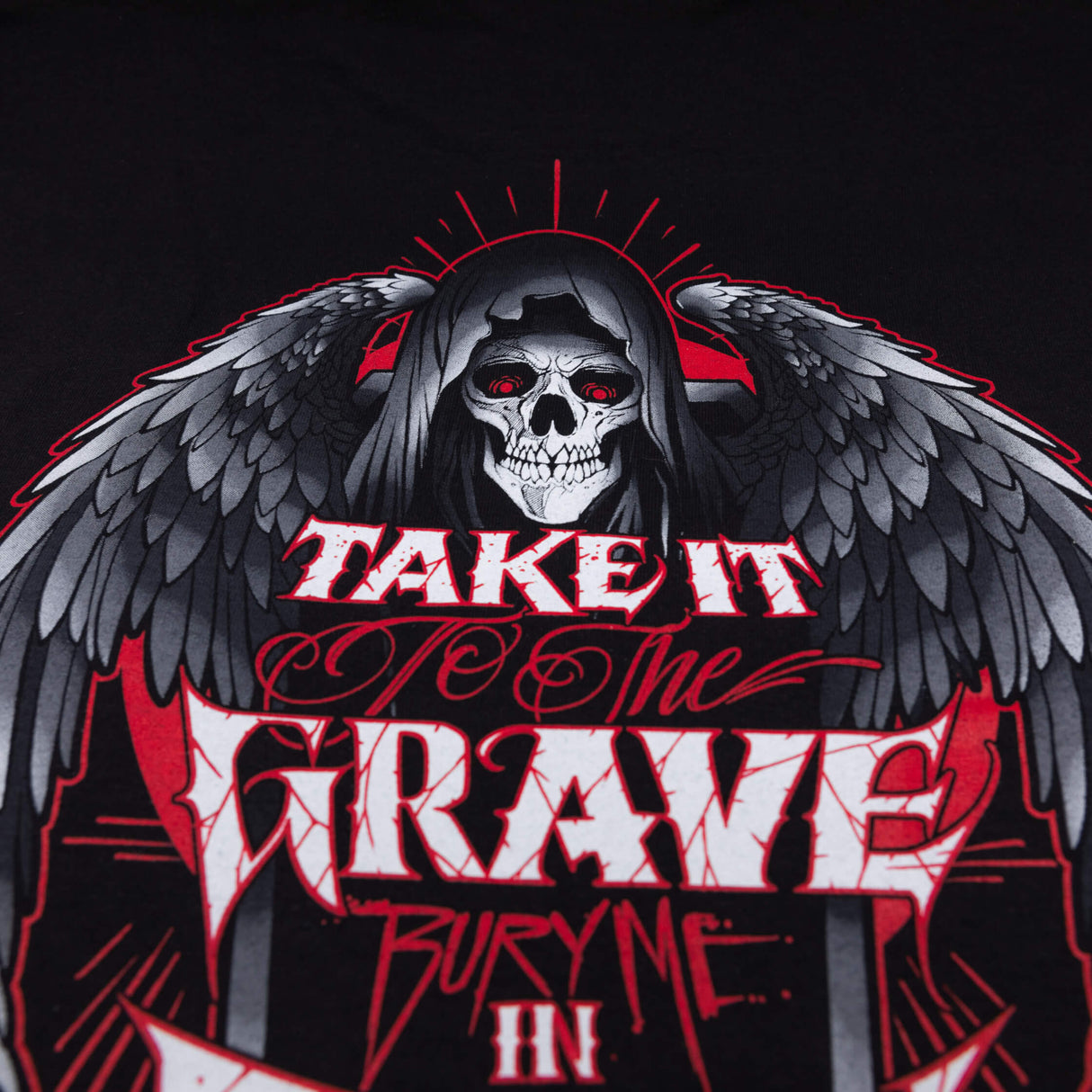 Black graphic T-shirt close-up of large back skull-and-wings emblem with red accents