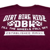 Burgundy T-shirt close-up of large back DBK print with “Till the Wheels Fall Off”