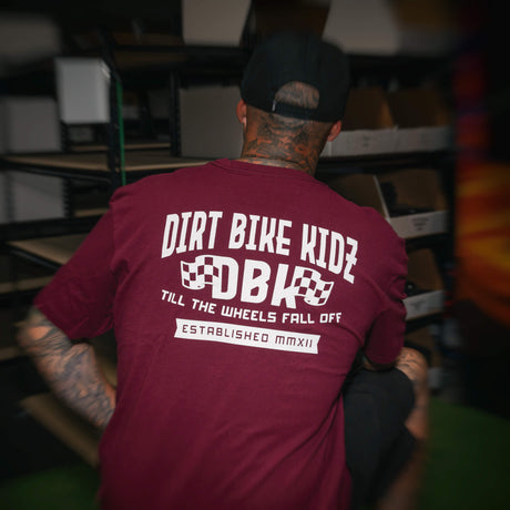 Burgundy T-shirt showing the large back DBK “Till the Wheels Fall Off” graphic