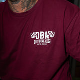 Maroon graphic T-shirt close-up of chest DBK logo with “Dirt Bike Kidz” beneath