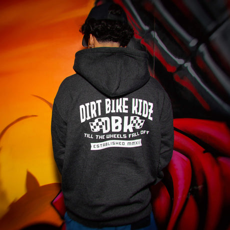 Kids dark hoodie worn, hood up, large back graphic print on the hood and center