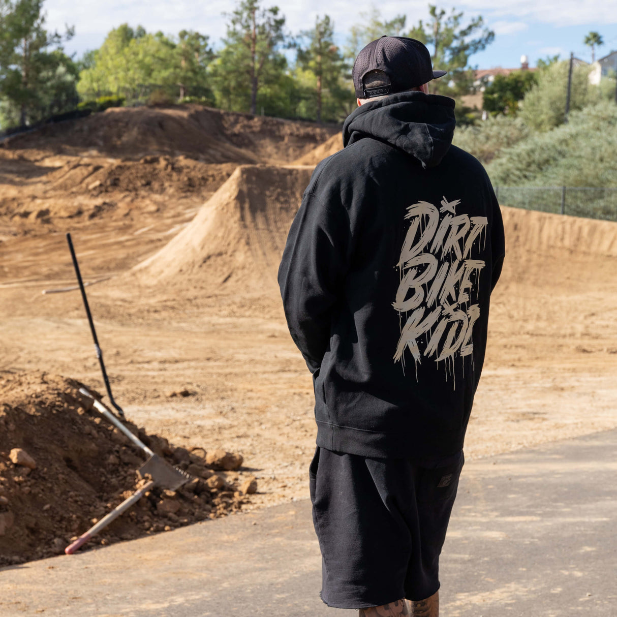 Black hoodie with large gold graphic on back and hood with drawstrings