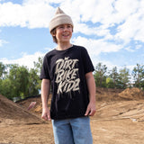 Youth black tee with beige DRRT BIKE RIDE graphic, worn with knit beanie.