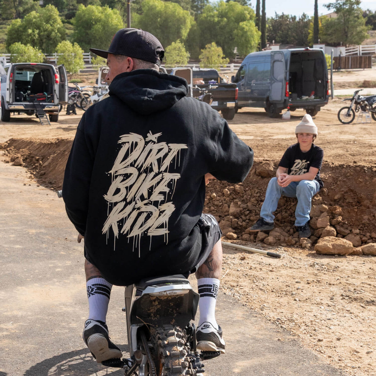Black hoodie with large gold back graphic and hood drawstrings