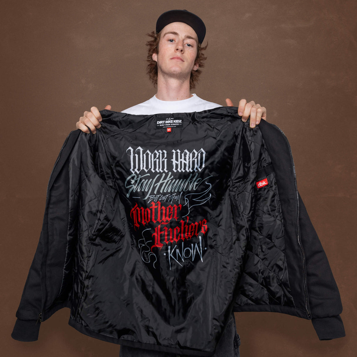 Deluxe jacket with open front showing black quilted interior and graphic print