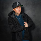 Black zip-front jacket with chest pockets and visible interior hood lining