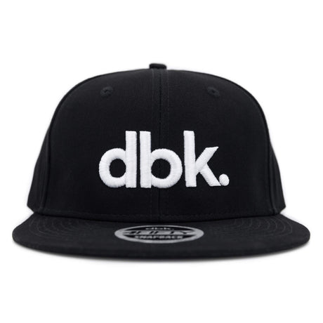Black snapback cap front view with large white dbk logo and flat brim.