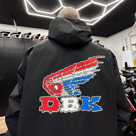 Black windbreaker jacket with hood and large colorful graphic on back