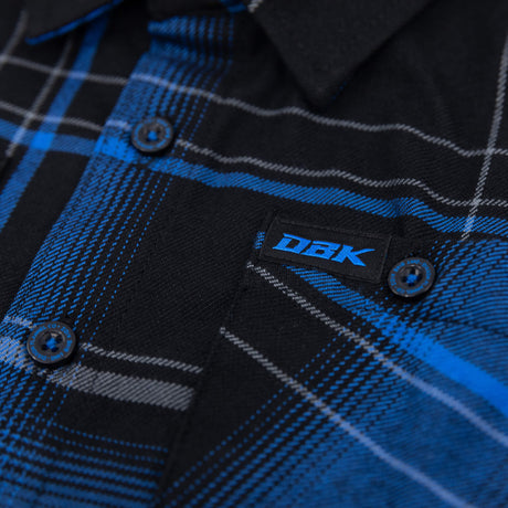 Youth flannel plaid shirt button and embroidered DBK label on blue-and-black fabric