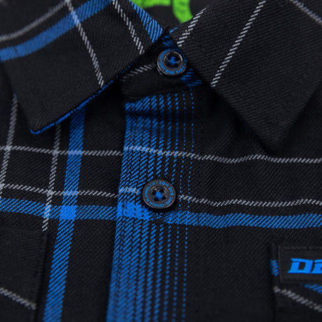 Youth flannel shirt close-up: black and blue plaid, button-down collar, blue buttons