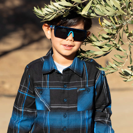 Youth flannel shirt with blue and black plaid, chest pockets, button front