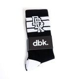 Black crew sock with white horizontal stripes, top graphic, and heel toe contrast.