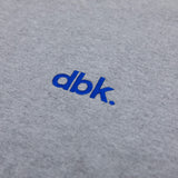 Heather gray crew T-shirt with blue dbk logo close-up