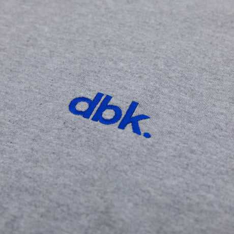 Heather gray crew T-shirt with blue dbk logo close-up
