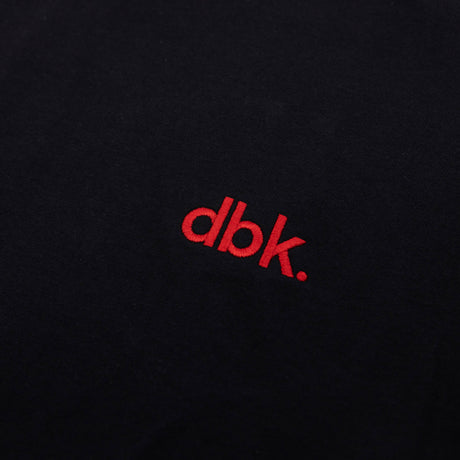 Black crew T-shirt with red dbk logo close-up