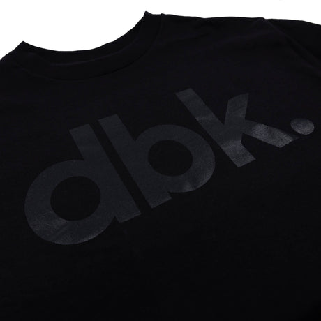 Black dbk graphic T-shirt close-up of front logo