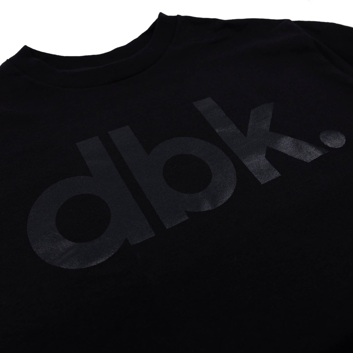 Youth premium tee, black with dbk. logo print on chest (close-up)