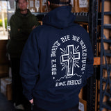 Navy hoodie back view with large white cross graphic and lettering, hood and pocket.