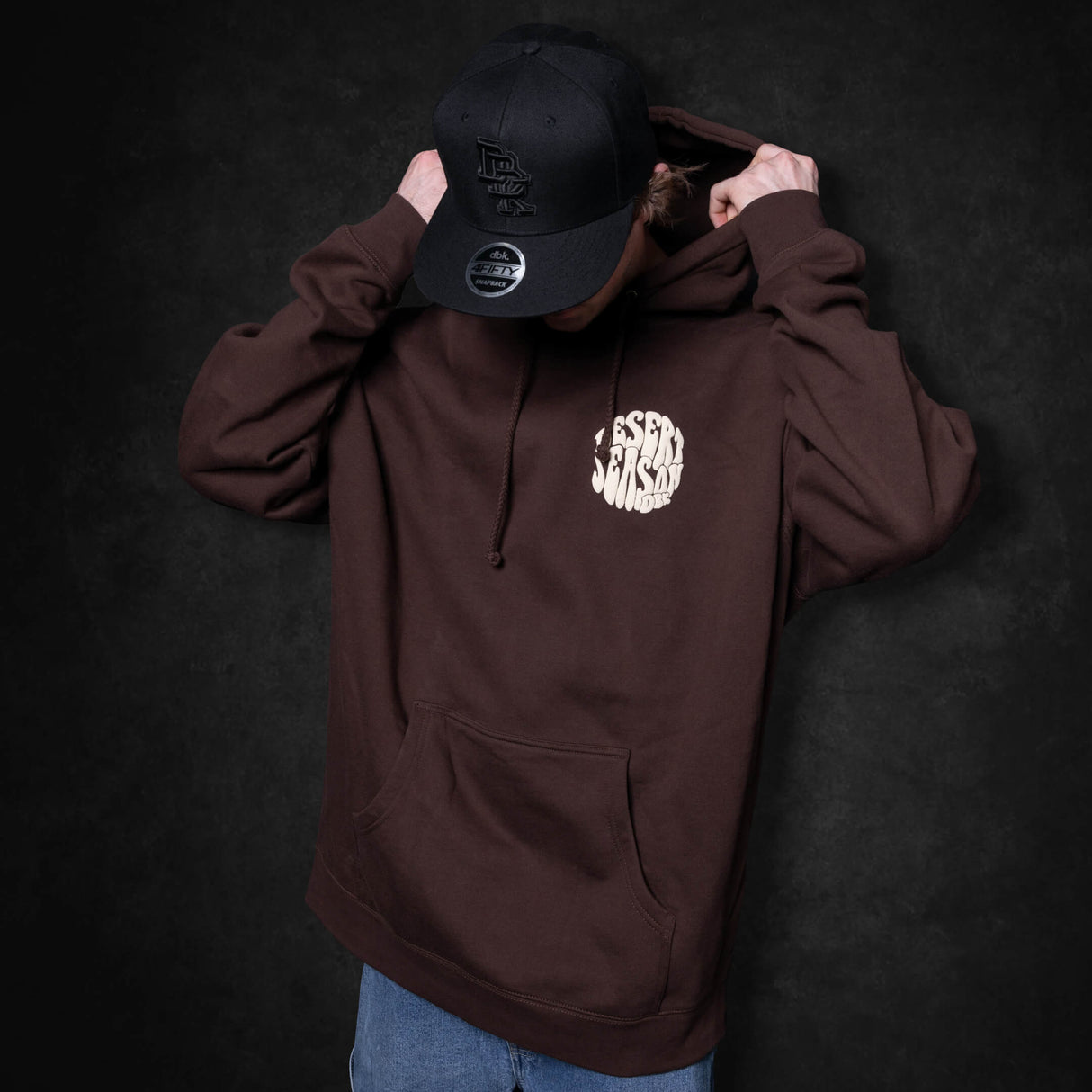Dark brown hoodie pullover with hood and front pocket; Desert Season chest logo