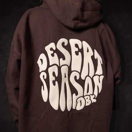 Dark brown Desert Season hoodie with large back graphic print and attached hood