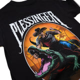 Black youth T-shirt large front graphic showing a cowboy punching while riding a green crocodile.