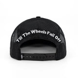 Black youth cap with mesh back and arched text on the rear panel