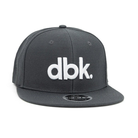 Charcoal snapback cap, side view with white "dbk" logo and flat brim